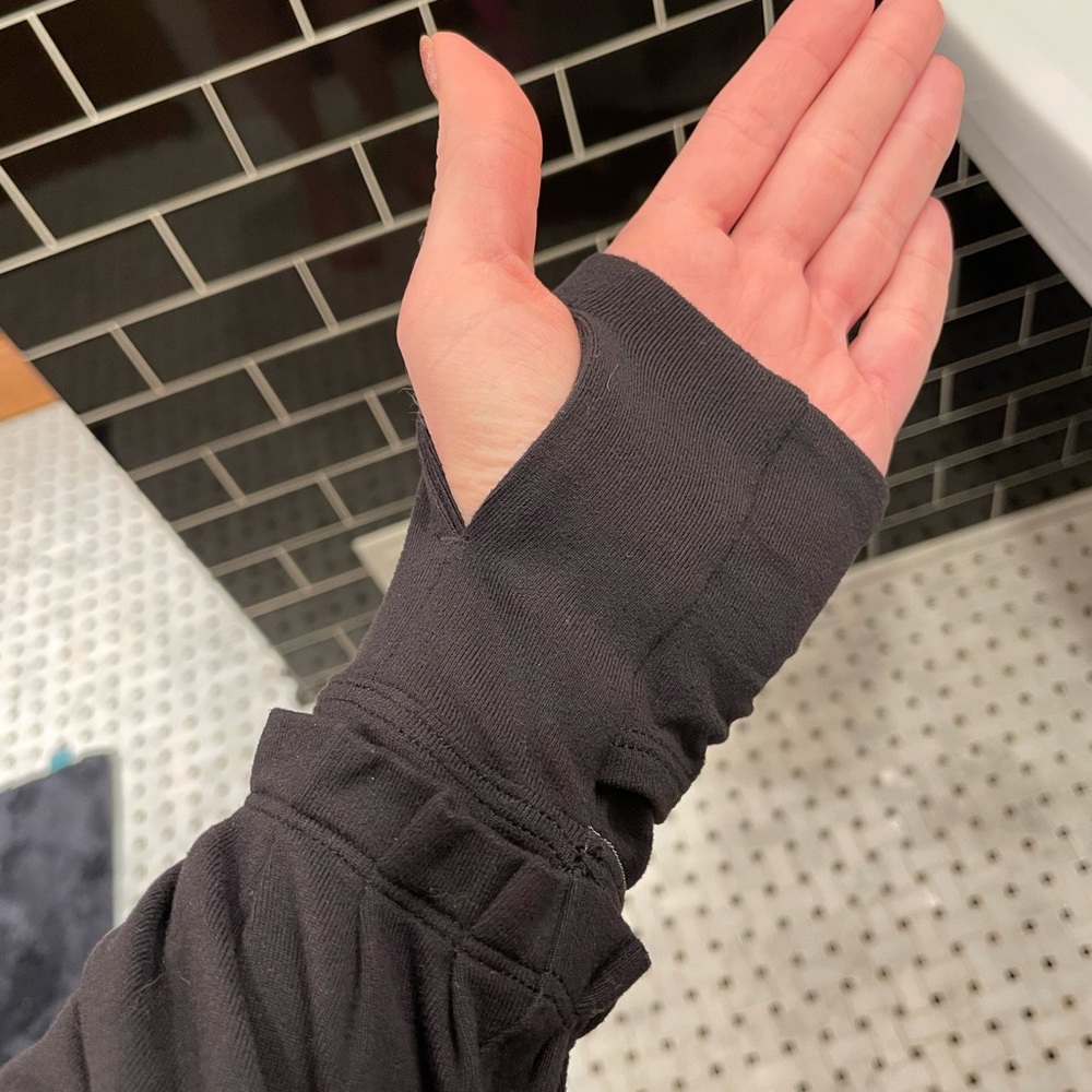 Lululemon black warm up long sleeved with hood and convertible detail at hands